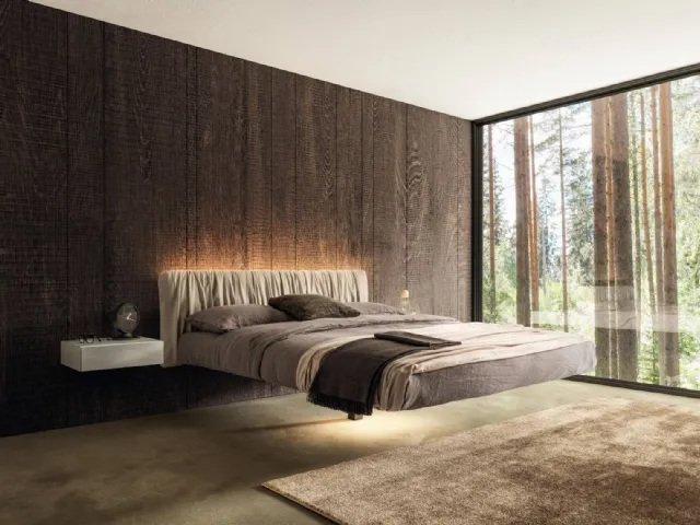 Suspended Bed Fluttua 1631 with pleated fabric headboard by Lago.