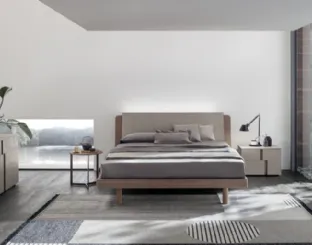 Bed in amber walnut and cava cement with Roxy headboard by Tomasella.