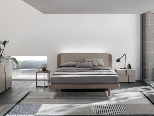 Bed in amber walnut and cava cement with Roxy headboard by Tomasella.