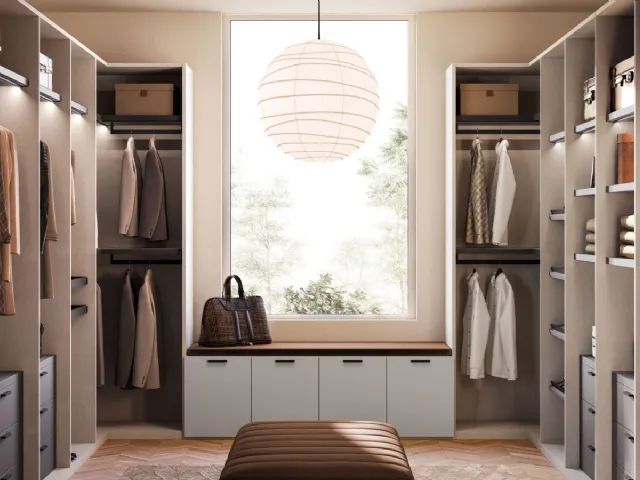 Open walk-in closet in matte lacquer and metal by Orme.